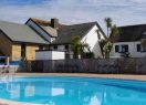 Main facilities building at Beachside Holiday Park, with swimming pool in foreground