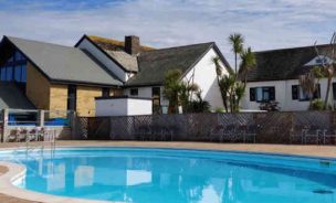 Main facilities building at Beachside Holiday Park, with swimming pool in foreground